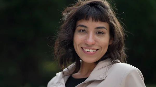 A hispanic woman with indigenous traits smiling at camera. Portrait face closeup of South American person