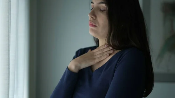 Worried Woman Standing Window Touching Her Neck Chest Seeking Comfort — 图库照片