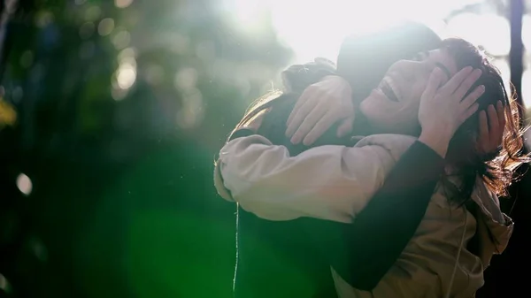 Two best friends reunion. Female friendship hug and embrace. Friends hugging girlfriend outdoors in sunlight. Real life love