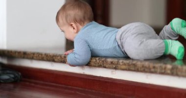 Baby infant learning to climb down step. Toddler development