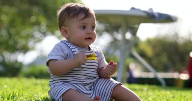 Adorable baby infant toddler boy child outside in nature