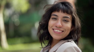A hispanic woman with indigenous traits smiling at camera. Portrait face closeup of South American person