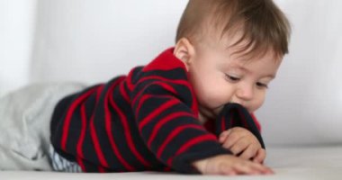 Adorable baby infant biting sweater