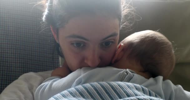 Thoughtful Contemplative Mother Holding Sleeping Baby — Stockvideo