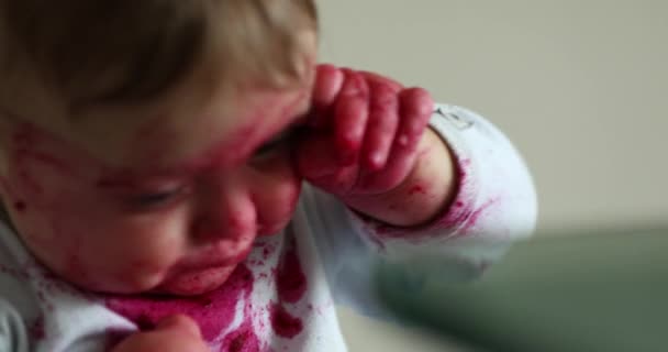 Tired Exhausted Baby Rubbing Eyes Hand Infant Covered Beet Sauce — Stock video