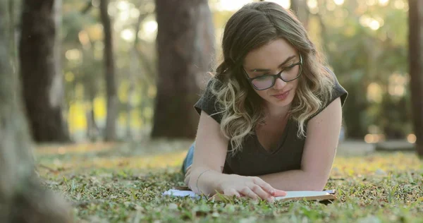 Smart Intelligent Girl Wearing Glasses Lying Grass Park Reading Book — Stok fotoğraf