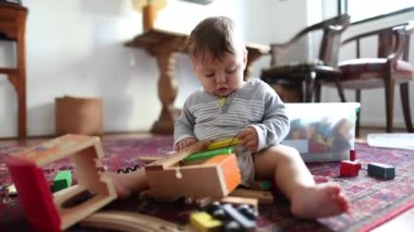 Baby child at home playing with toys indoors