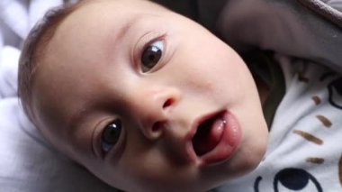 Sweet cute baby infant boy smiling to camera