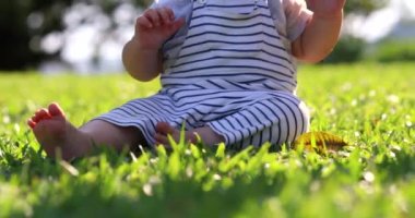 Baby toddler on ground grass outdoors
