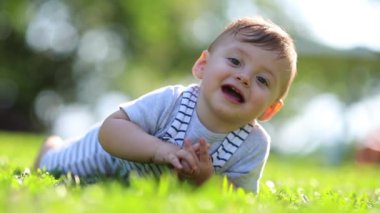 Cute baby toddler learning about the world crawling outside in nature