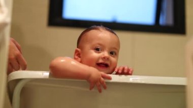 Adorable beautiful baby toddler inside bathtub. Bathing, cleaning, washing, cute baby infant