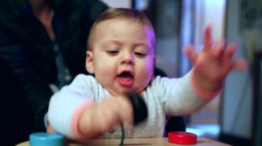 Baby toddler playing with traditional wooden toy