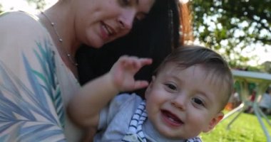 Cute babyw with mother outside in the sunlight