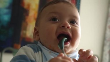 Happy joyful baby infant face portrait closeup. toddler boy smiling and feeling joy during meal