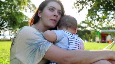 Authentic real life mother and baby relationship in outdoor park