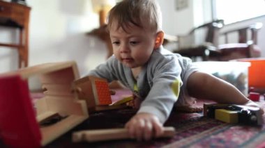 Cute baby toddler playing with toys indoors on the floor