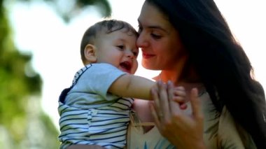Mom holding baby son loving and caring relationship
