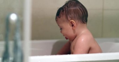 Happy cute baby inside bathtub