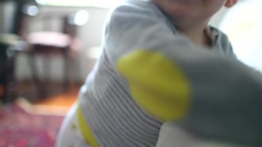 Toddler baby holding into couch learning to stand
