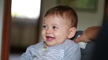 Baby spontaneous smile laugh, child giggle, toddler smiling to camera