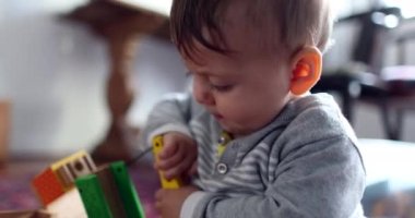 Infant baby boy toddler playing with toys