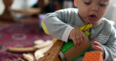 Infant baby boy toddler playing with toys