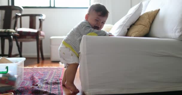Upset Baby Toddler Learning Stand Leaning Sofa Indoors — Video Stock