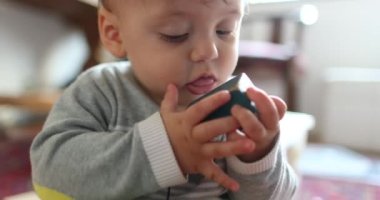 Baby toddler holding piece cubic toy discovering object