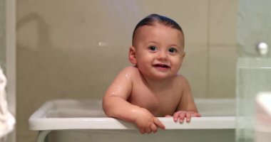 Bathing smiling happy cute adorable baby toddler infant inside bathtub