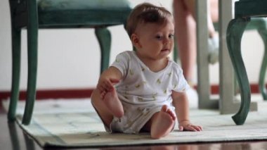 Adorable baby infant crawling on floor at home. Toddler development