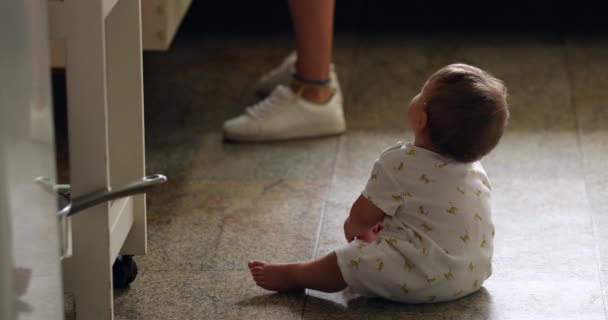 Baby Sitted Kitchen Floor Looking Mother Cooking Candid Real Life — Vídeo de Stock