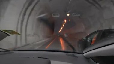 Car entering tunnel POV passenger inside vehicle on hgihway road