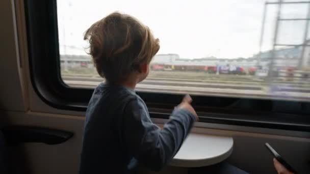 Adorable Child Traveling Train Looking Out Window — Vídeo de Stock