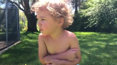 Toddler baby boy getting up outdoors