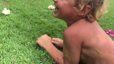 Baby toddler getting up from the ground, outdoors
