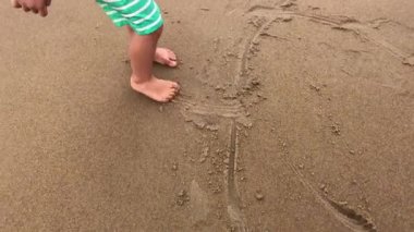 Happy Baby boy playing at the beach