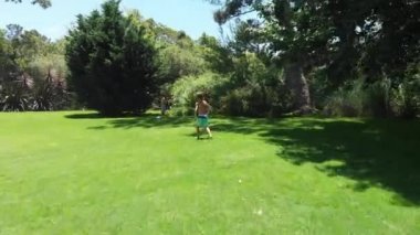 Children playing soccer outside at home lawn