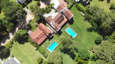 Aerial drone of suburban home wirth lawn and swimming pool