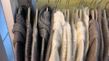 Winter clothing on display at store, hanging on hangers