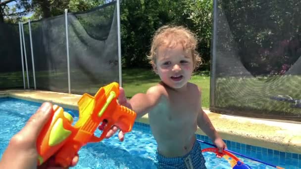 Teasing Toddler Boy Wanting Grab Gun Toy Pool — Wideo stockowe