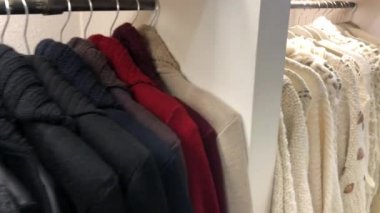 Collection of sweaters on hangers