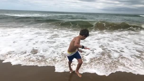 Boy Backing Out Sea Shore Water Afraid Getting Wet — Stock Video