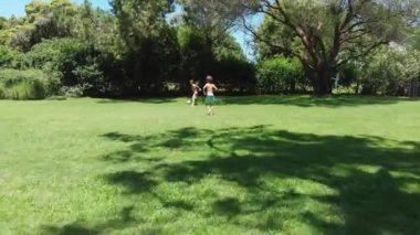 Children playing soccer outside at home lawn