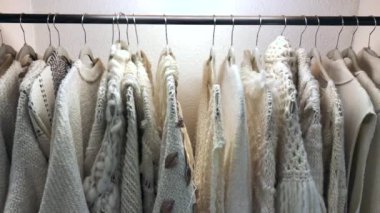 Collection of Clothing hanging on hangers, white