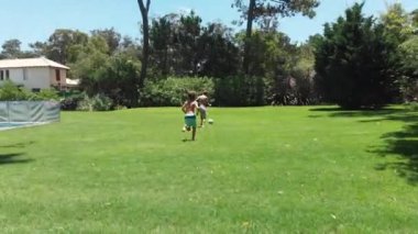 Children playing soccer outside at home lawn