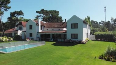 Beautiful exterior of home. green grass and swimming pool