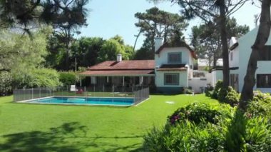 Beautiful traditional home exterior. Real estate house with lawn and pool