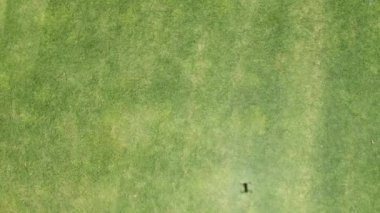 Drone perspective of children running at home lawn