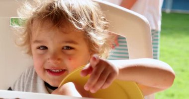 Baby boy child talking and pointing finger to camera, candid