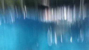 Child swimming at pool in super slow-motion